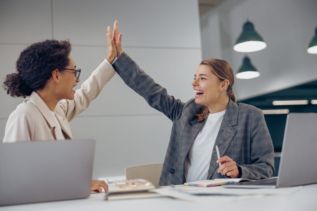 cheerful,successful,businesswomen,giving,five,celebrating,project,victory,in,modern